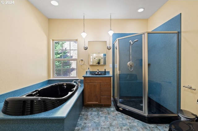 bathroom featuring plus walk in shower and vanity