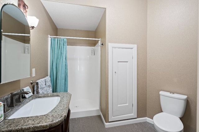 bathroom featuring vanity, toilet, and a shower with shower curtain