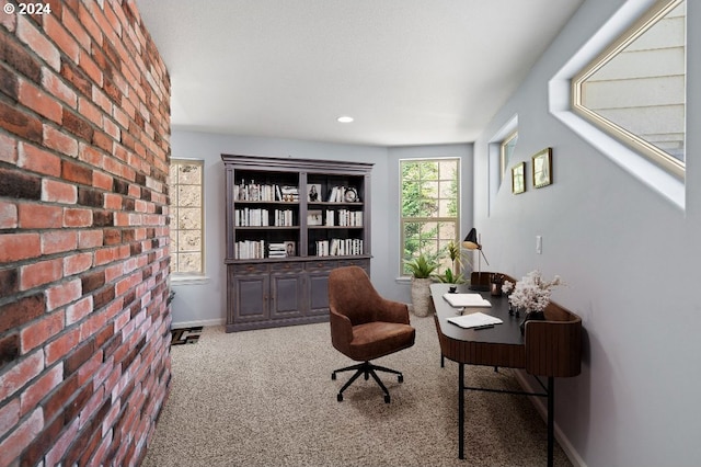 office space featuring brick wall and carpet flooring