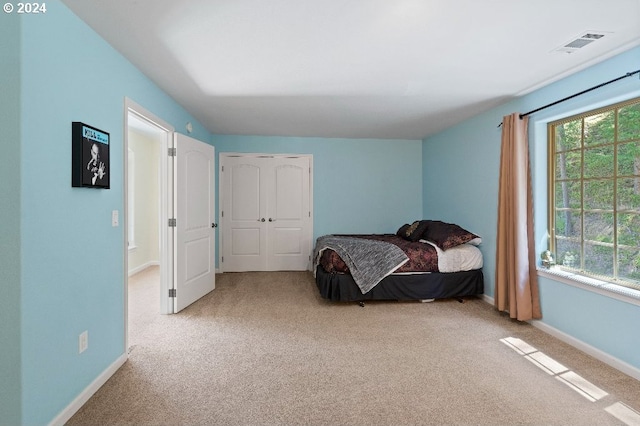 bedroom featuring light carpet