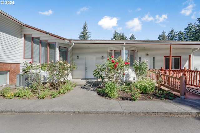 ranch-style house with covered porch and central AC