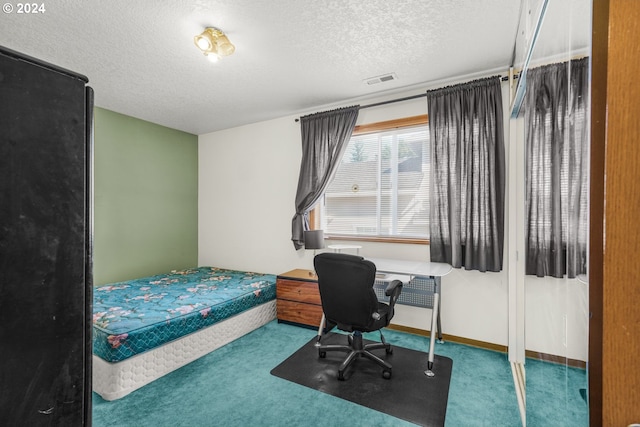 carpeted bedroom with a textured ceiling