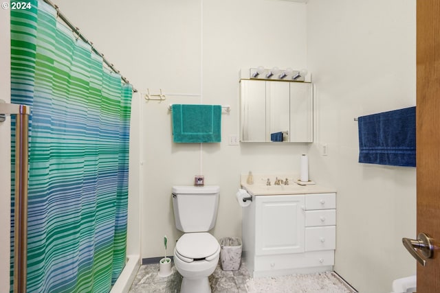 bathroom featuring vanity, toilet, and curtained shower