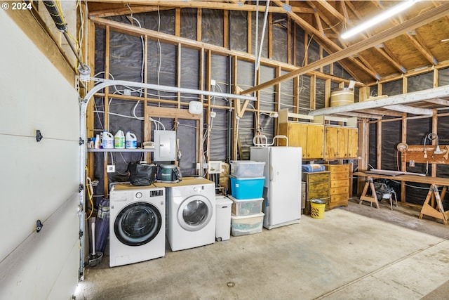 basement with white fridge, electric panel, and separate washer and dryer