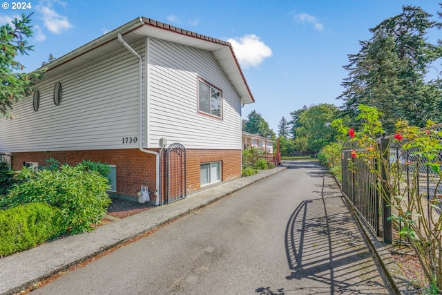 1730 SE 148th Ave, Portland, OR 97233 - view of side of home with brick siding and fence