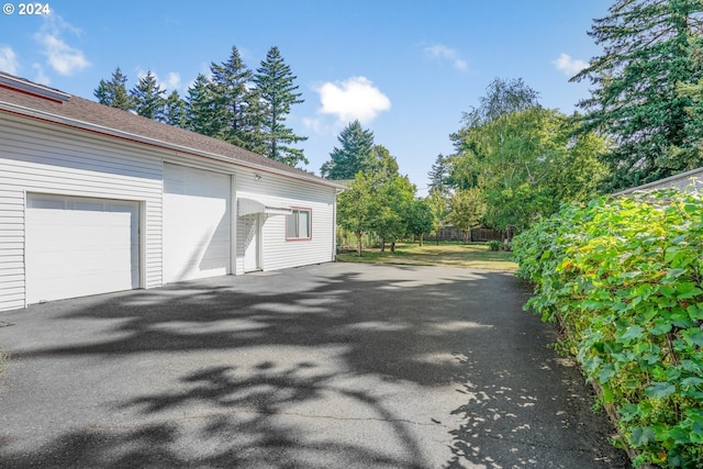 view of side of property with a garage