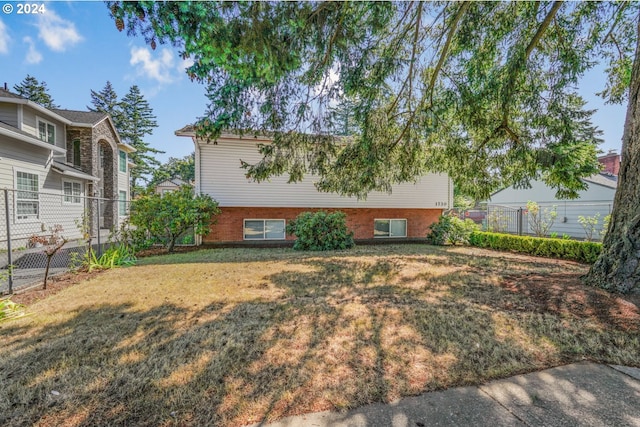 1730 SE 148th Ave, Portland, OR 97233 - view of front of house with a front yard, brick siding, and fence