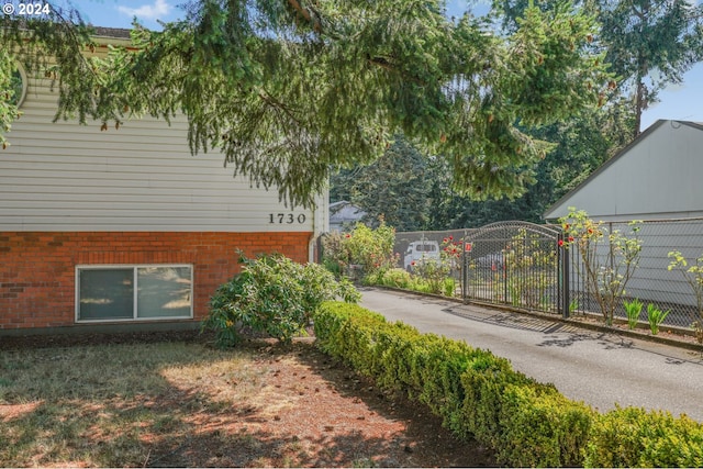 1730 SE 148th Ave, Portland, OR 97233 - view of home's exterior featuring brick siding and fence