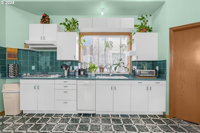 kitchen featuring dishwasher, sink, decorative backsplash, and white cabinets