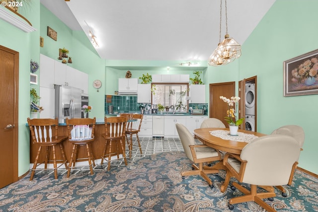 1730 SE 148th Ave, Portland, OR 97233 - dining room featuring high vaulted ceiling and stacked washing maching and dryer