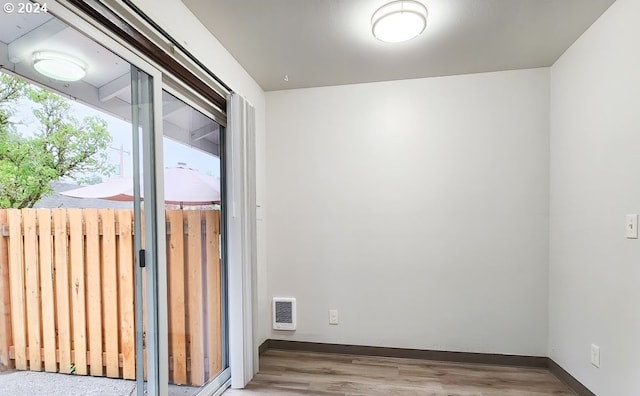 empty room featuring light hardwood / wood-style floors and heating unit