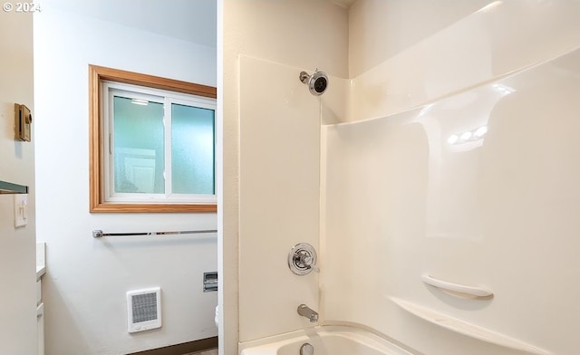 bathroom featuring vanity, heating unit, and shower / bathtub combination