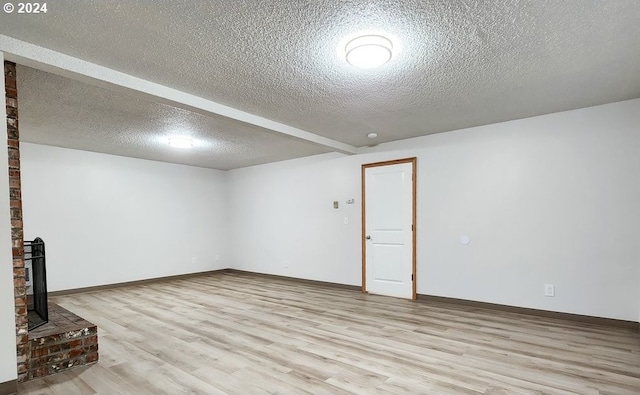 interior space featuring light hardwood / wood-style floors and a textured ceiling