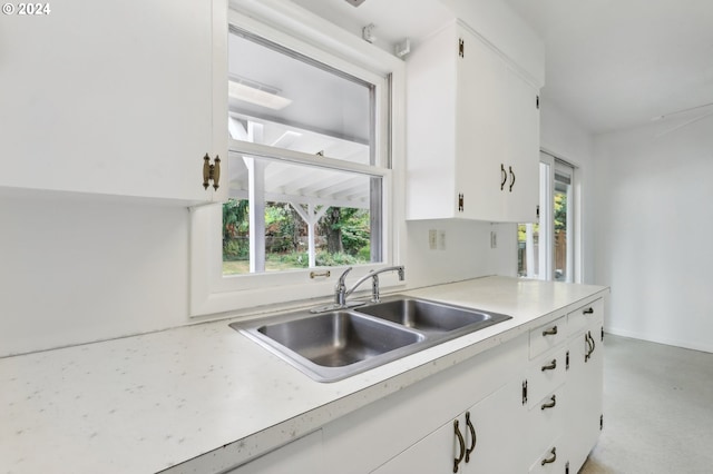 kitchen featuring sink, white cabinets, and plenty of natural light