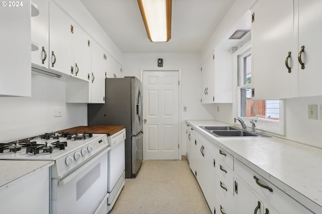 kitchen with white cabinets, sink, and white range with gas cooktop