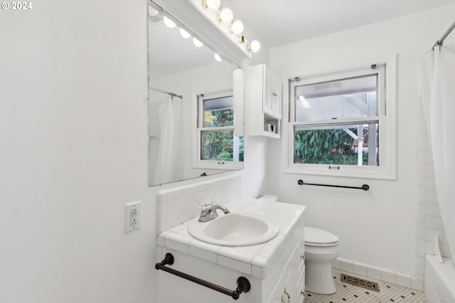 full bathroom with toilet, shower / bath combination with curtain, vanity, and tile patterned floors