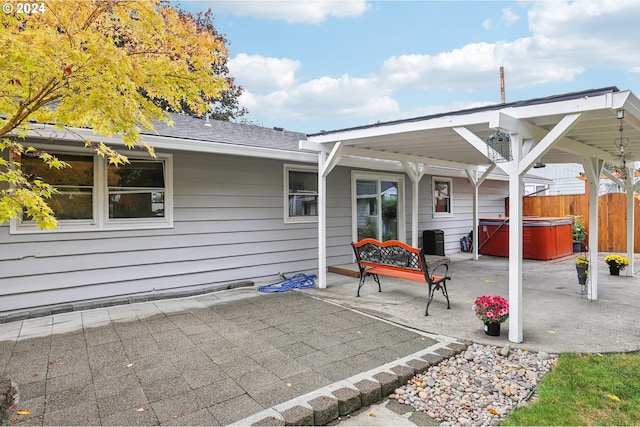 view of patio / terrace with a hot tub