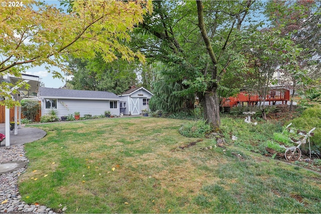 view of yard with a storage shed and a wooden deck