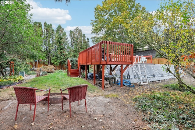 view of yard with a fire pit and a wooden deck