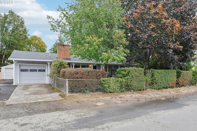single story home with fence, an attached garage, driveway, and a chimney