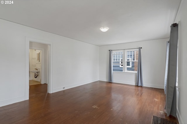 unfurnished room featuring dark hardwood / wood-style flooring