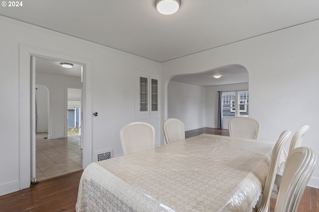 dining room featuring plenty of natural light and dark wood-type flooring