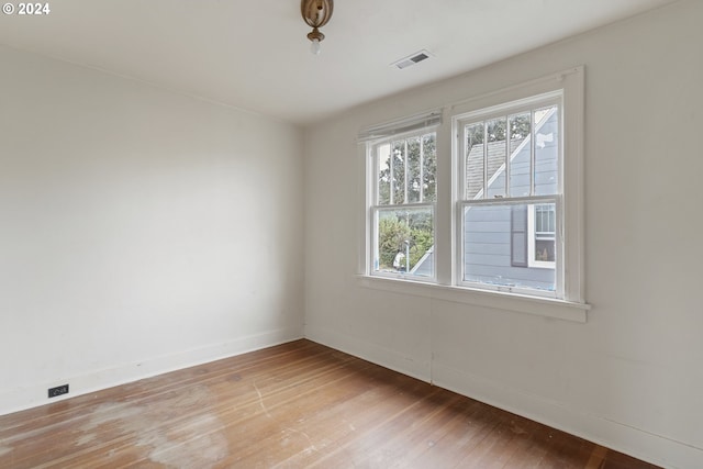 unfurnished room with hardwood / wood-style flooring