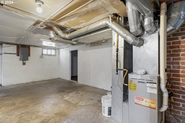 basement featuring electric panel and brick wall