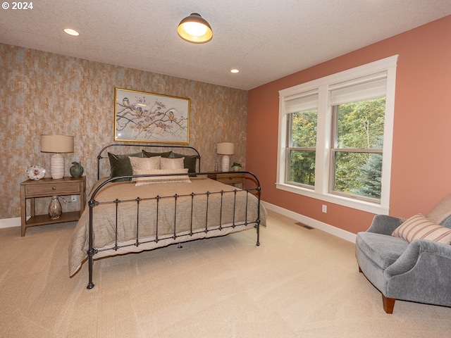 carpeted bedroom with a textured ceiling