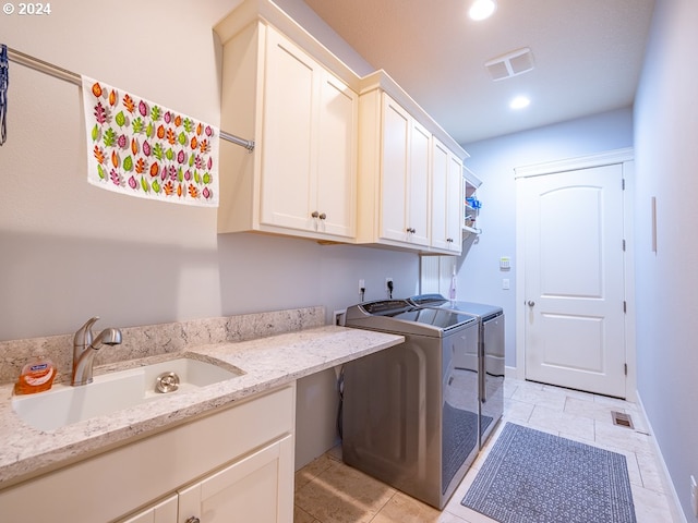 washroom with cabinets, independent washer and dryer, sink, and light tile patterned floors