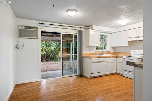 3314 SE 85th Ave, Portland, OR 97266 - kitchen with white appliances, under cabinet range hood, white cabinets, light wood-type flooring, and a textured ceiling