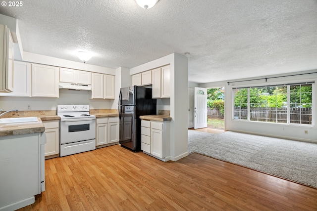 3314 SE 85th Ave, Portland, OR 97266 - kitchen featuring electric stove, a sink, freestanding refrigerator, under cabinet range hood, and open floor plan