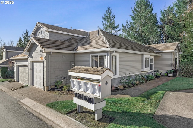 view of front of property featuring an attached garage and driveway