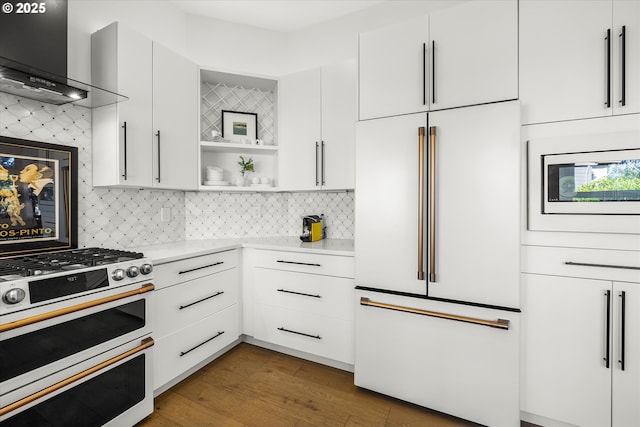 kitchen with open shelves, light countertops, high quality fridge, wall chimney range hood, and double oven range