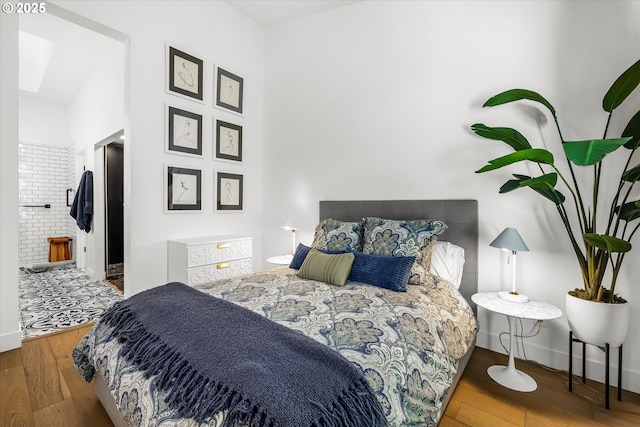 bedroom with baseboards and wood finished floors