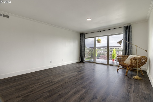 spare room with ornamental molding and dark hardwood / wood-style flooring