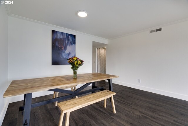 dining area featuring ornamental molding and dark hardwood / wood-style flooring