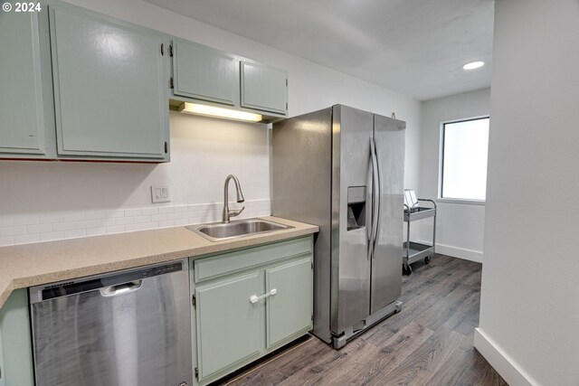 kitchen featuring appliances with stainless steel finishes and dark hardwood / wood-style floors