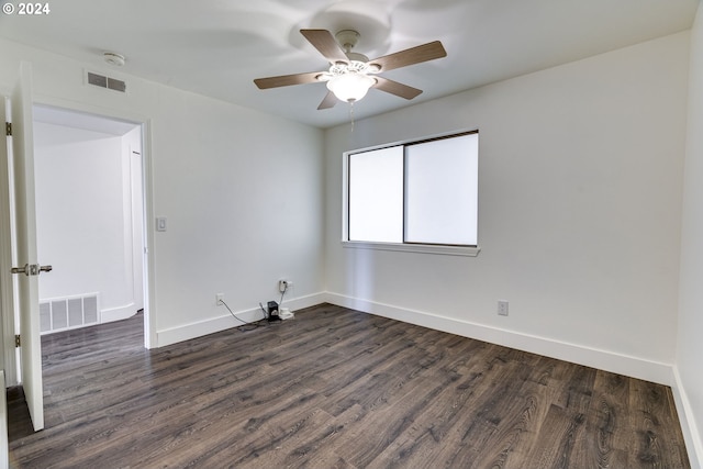 empty room with dark hardwood / wood-style floors and ceiling fan