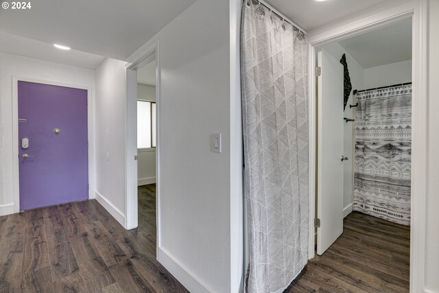 unfurnished bedroom featuring dark hardwood / wood-style flooring, a closet, and ceiling fan