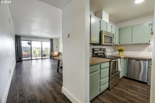 kitchen with appliances with stainless steel finishes, dark hardwood / wood-style flooring, and green cabinets