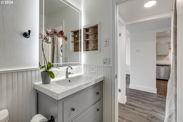 bathroom with vanity, toilet, and wood-type flooring