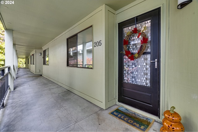 view of exterior entry featuring covered porch