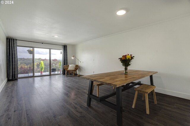 dining room with crown molding and dark hardwood / wood-style flooring