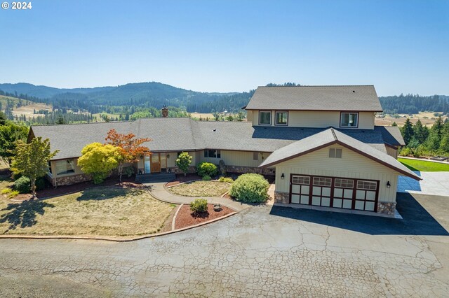 view of front of property with a garage and a mountain view