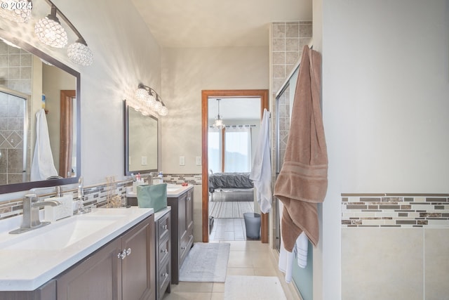 bathroom with vanity, a shower with shower door, and tile patterned flooring