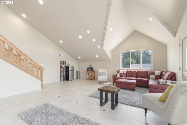 tiled living room featuring high vaulted ceiling