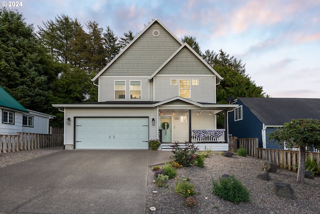 front of property with a garage and covered porch