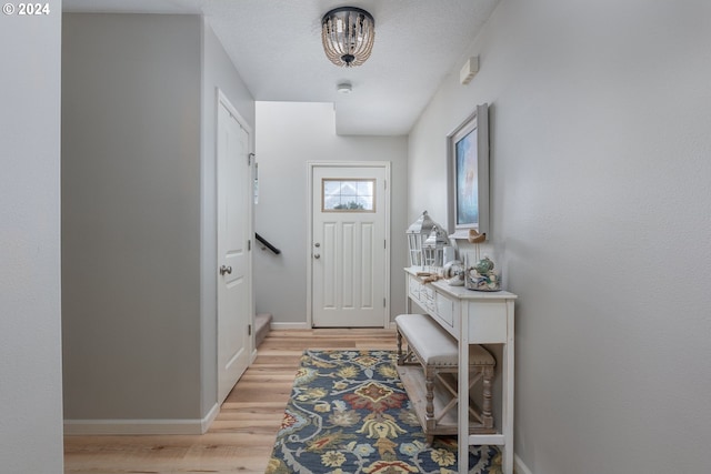 foyer entrance featuring light hardwood / wood-style floors and a textured ceiling