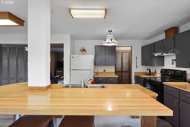 kitchen featuring sink, hanging light fixtures, black electric range, a textured ceiling, and white fridge